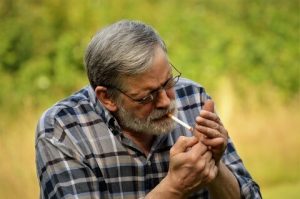 Personne âgée fumant une cigarette, souhaitant arrêter de fumer
